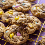Make These Gluten Free Mini Egg Cookies Today 11 Gluten free mini egg cookies stacked on a plate with crushed candy visible