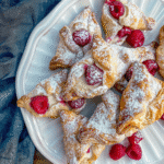 Danish pastry raspberry 13 Plate of golden danish pastry raspberrydusted with powdered sugar