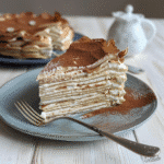 The Best Tiramisu Crepe Cake Recipe (Easy and Delicious) 9 tiramisu crepe cake slice with cocoa dusting