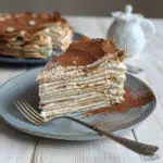 tiramisu crepe cake slice with cocoa dusting