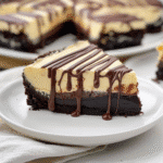 Cheesecake and Brownie Cake So Good It’s Addictive 9 Close-up of Cheesecake and Brownie Cake with thick ganache drizzle