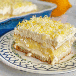 Limoncello Tiramisu Recipe 11 Slice of limoncello tiramisu on a plate topped with lemon zest