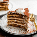 Crepe Cake Tiramisu You’ll Make Again And Again 11 Slice of Crepe Cake Tiramisu with visible creamy layers on a plate