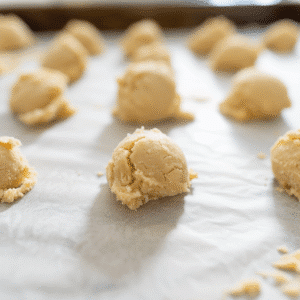 Crumble Sugar Cookie Recipe So Good You’ll Crave It 12 Crumbl sugar cookies cooling on a rack before frosting